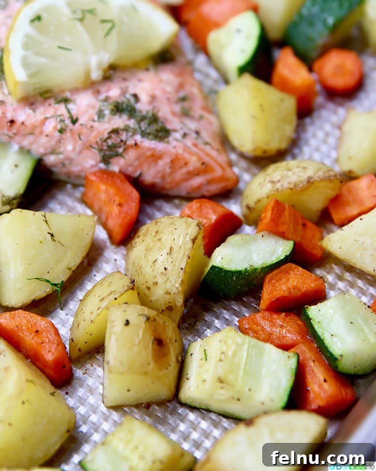 Effortless Oven Baked Salmon and Veggies 3 Assorted chopped vegetables including potatoes, carrots, and zucchini, ready for the sheet pan.