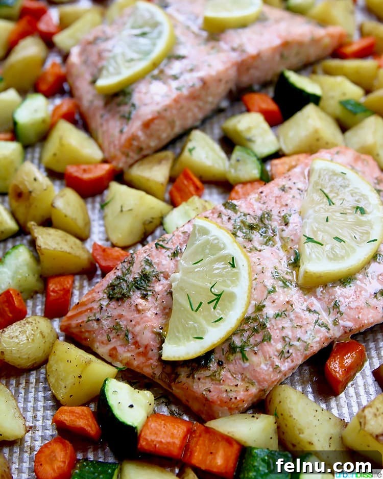 Effortless Oven Baked Salmon and Veggies 5 Close-up of perfectly cooked salmon fillet with roasted vegetables and fresh dill.
