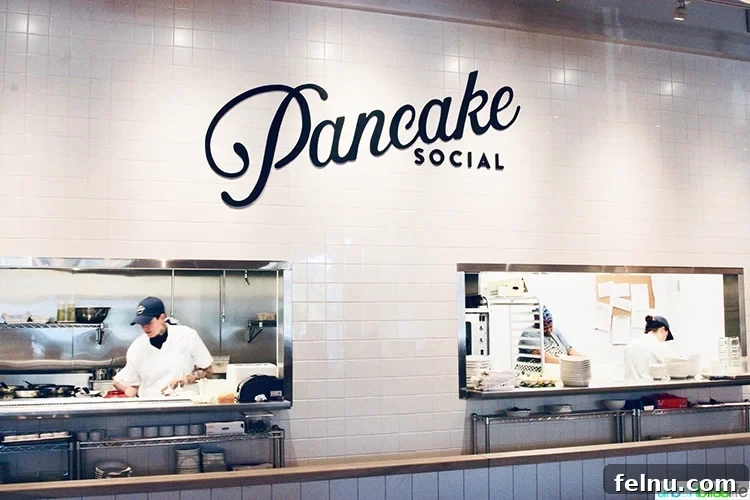 Atlanta's Hottest Dining Destinations 4 The bustling, open kitchen area of Pancake Social in Atlanta, showcasing a bright and inviting atmosphere.
