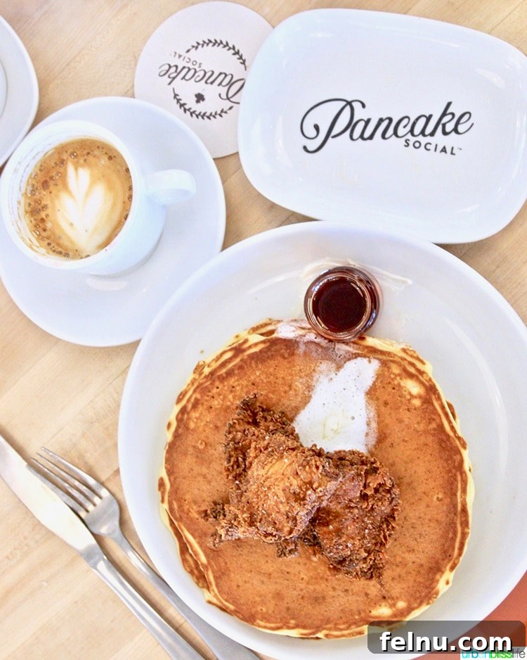 Atlanta's Hottest Dining Destinations 5 A close-up of a plate with chicken, pancakes, and coffee at Pancake Social in Atlanta, ready for a delicious brunch.