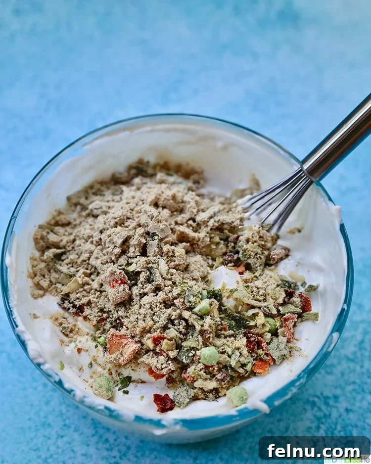 Effortless Creamy Spinach Dip (Dairy-Free) 4 Ingredients for dairy-free spinach dip being mixed in a bowl