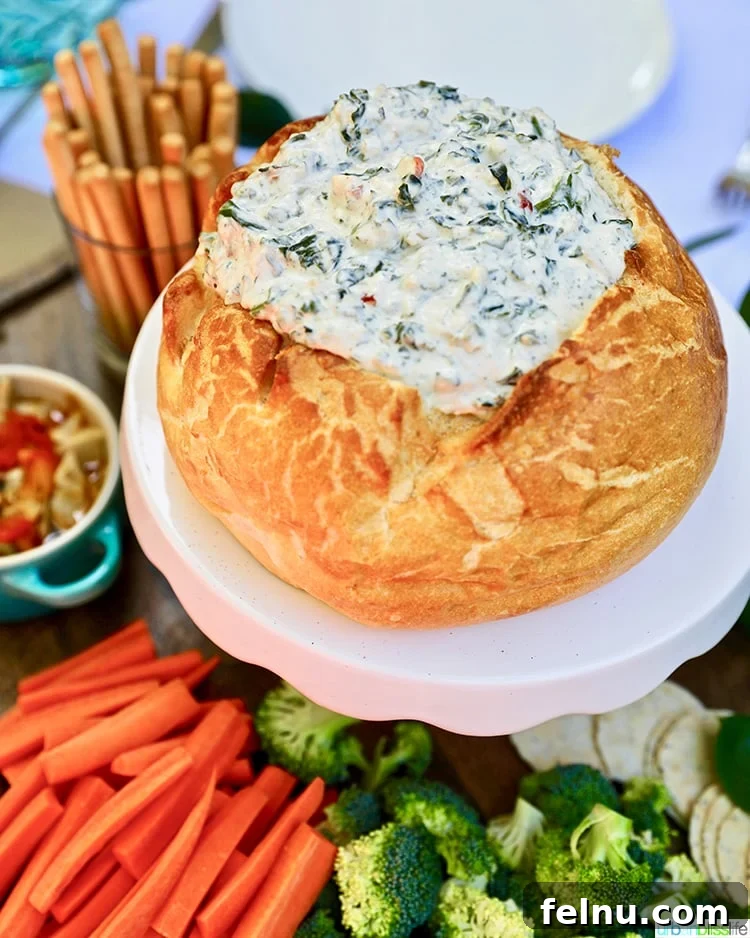 Effortless Creamy Spinach Dip (Dairy-Free) 5 Spinach dip served in a bread bowl with an assortment of fresh vegetables