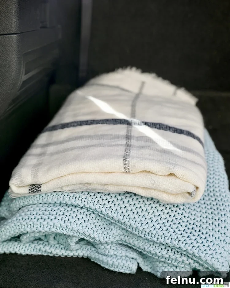 Autumn Drives: Essential Packing List 5 Soft blankets neatly folded, perfect for keeping warm on a fall road trip.