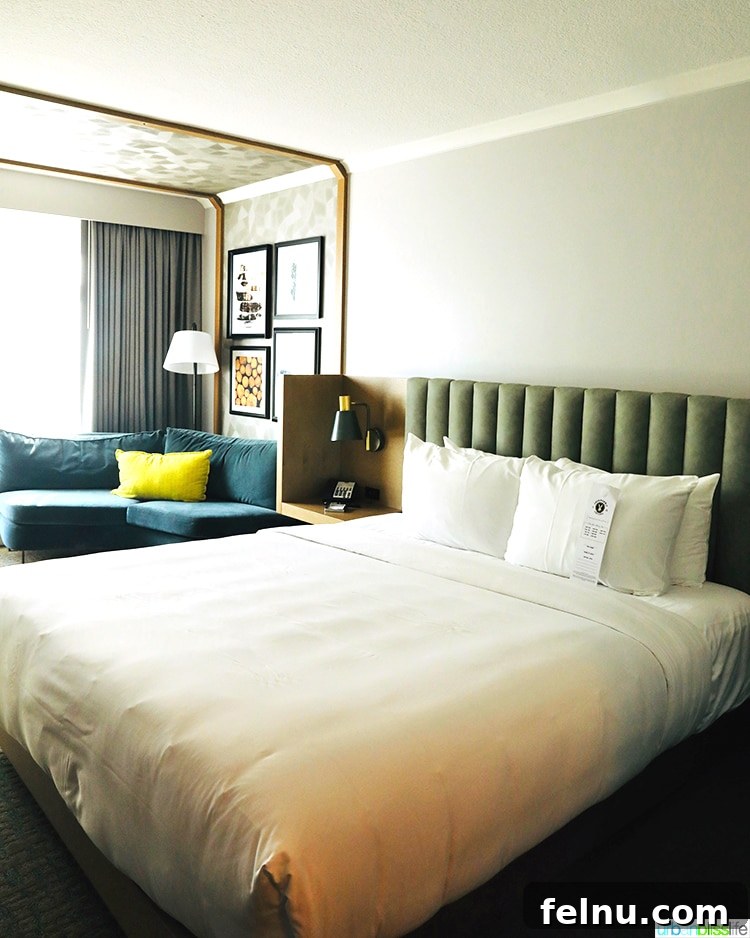 Portland Getaway: A Boutique Hotel Experience 2 Luxurious room at The Duniway Hotel Portland, featuring a comfortable bed and stylish couch.