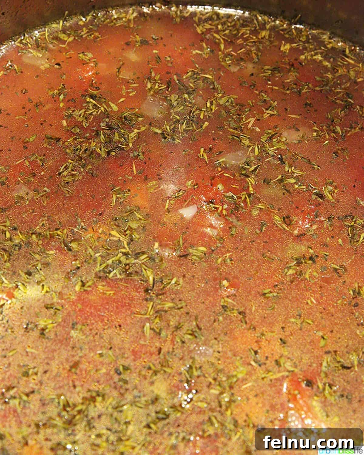Hearty Vegan Lentil Stew in Your Instant Pot 6 Vegetable broth being poured into the Instant Pot, covering the vegetables and lentils.