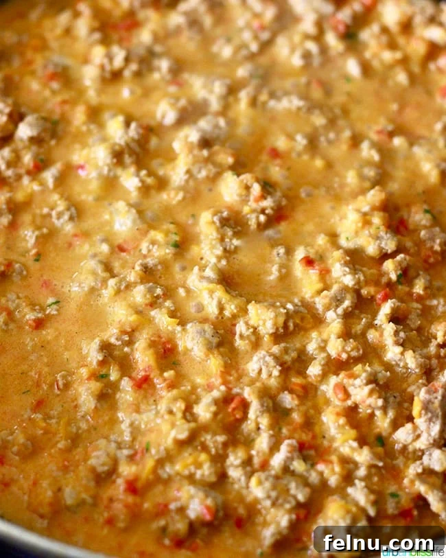 Vibrant Three Pepper Turkey Pasta 4 Ground turkey with peppers cooking in a pan for Tri-Pepper Turkey Pasta