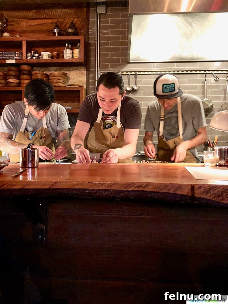 Celebrate in Style: Portland's Finest Restaurants 4 Langbaan Chefs in Kitchen preparing dishes with precision and artistry.