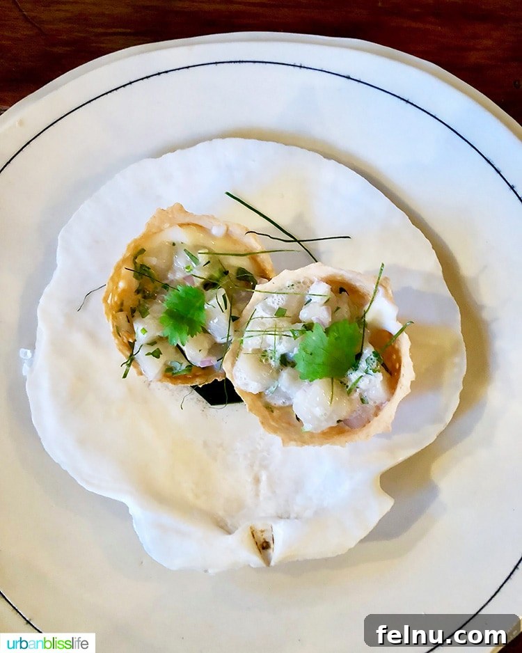 Celebrate in Style: Portland's Finest Restaurants 5 Exquisite scallops dish at Langbaan, beautifully presented.