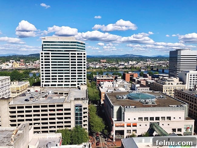 Celebrate in Style: Portland's Finest Restaurants 49 A panoramic view of Portland, Oregon, from the rooftop of Departure restaurant, showcasing the city lights.