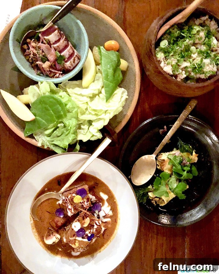 Celebrate in Style: Portland's Finest Restaurants 6 A selection of main dishes at Langbaan, showcasing vibrant colors and intricate plating.