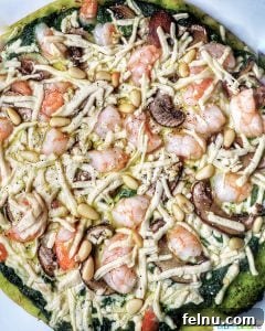 Emerald Ocean Pizza 9 shrimp pesto pizza on a baking tray, ready for the oven