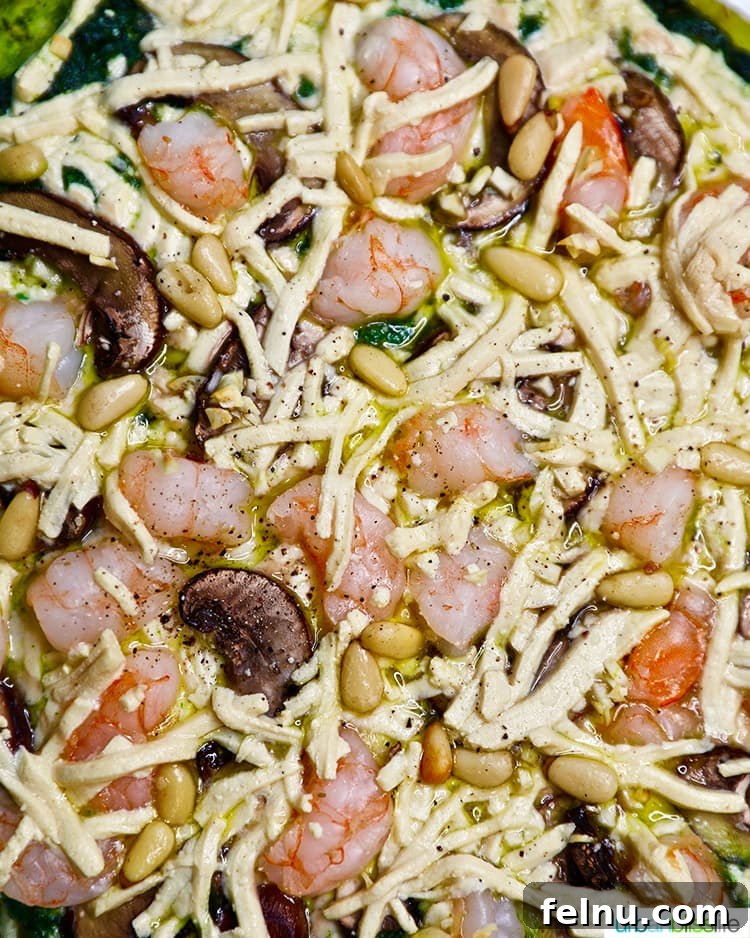 Emerald Ocean Pizza 5 Whole shrimp pesto pizza on a cutting board