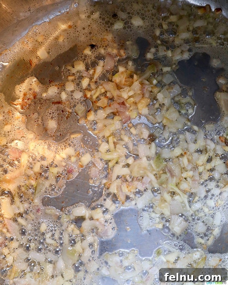 Mushroom Magic: Creamy Vegan Risotto in Minutes 6 Shallots and garlic sautéing in an Instant Pot.