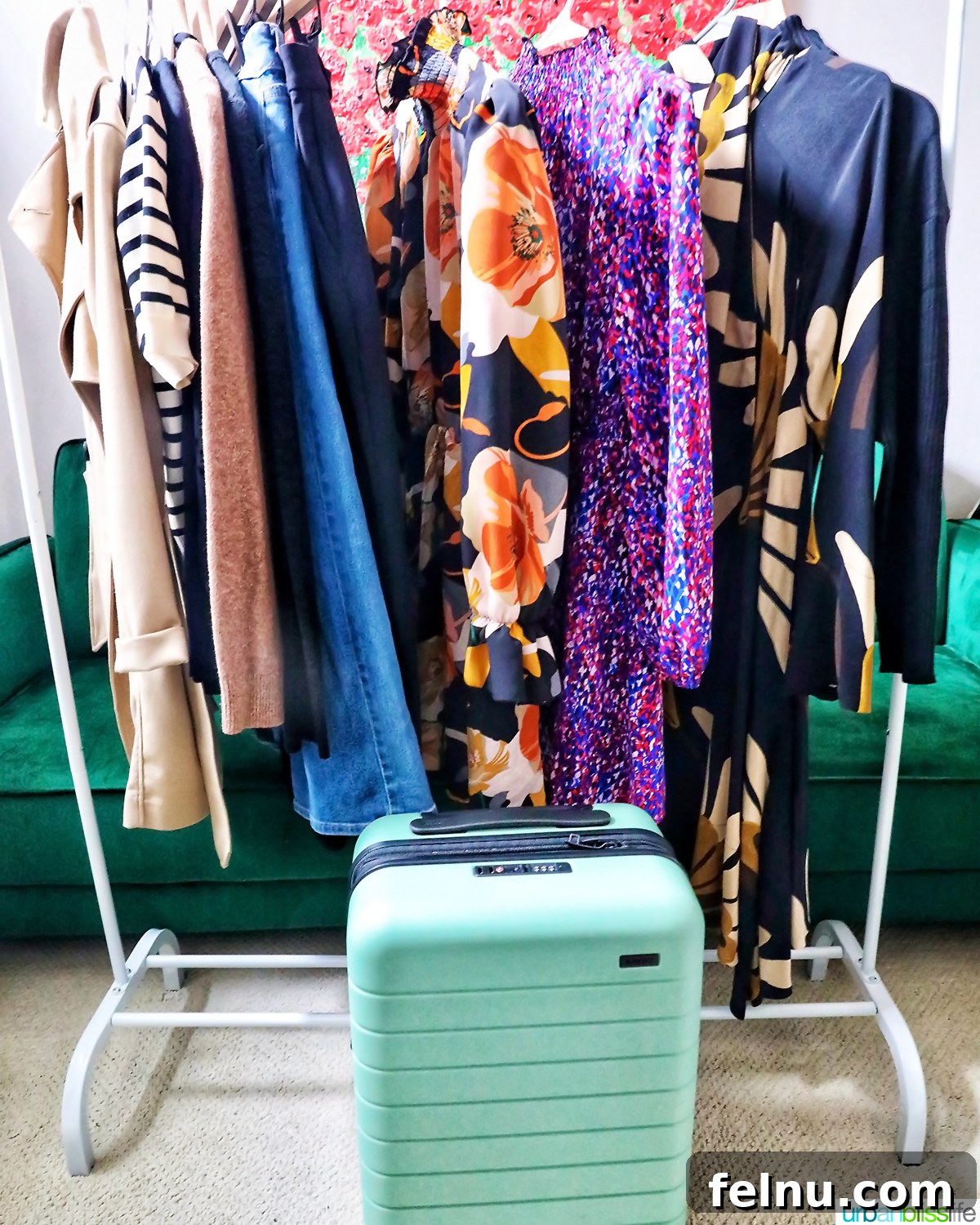 One Bag, One Week: Effortless Carry-On Packing 4 Organized travel clothes on a rack next to a green Away suitcase, showcasing efficient packing for a river cruise.