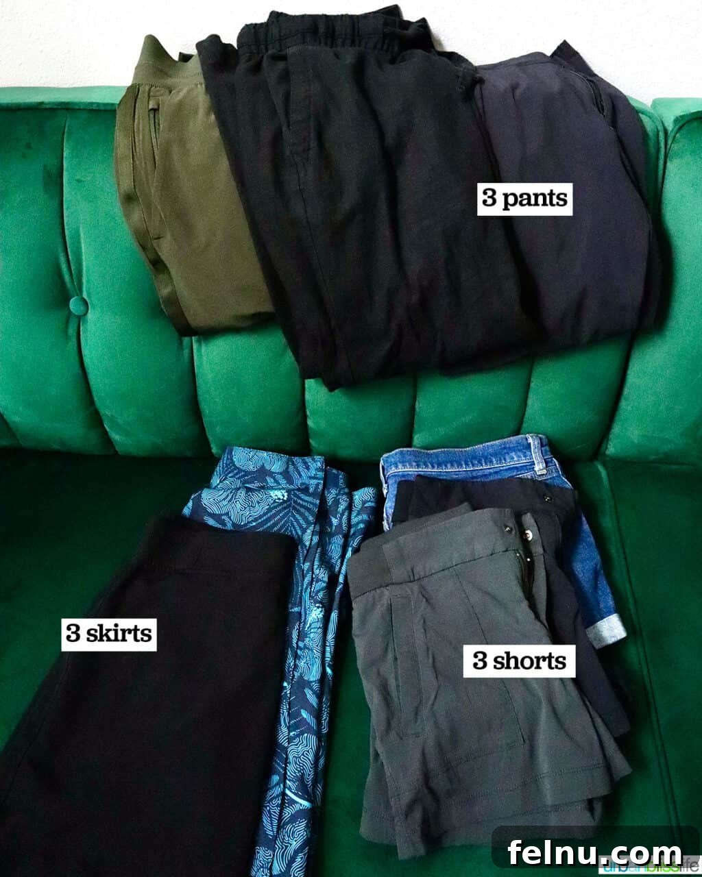 One Bag, One Week: Effortless Carry-On Packing 5 A curated selection of organized clothes on a green couch, showcasing items for a one-week carry-on packing list, including shorts, pants, and skirts.