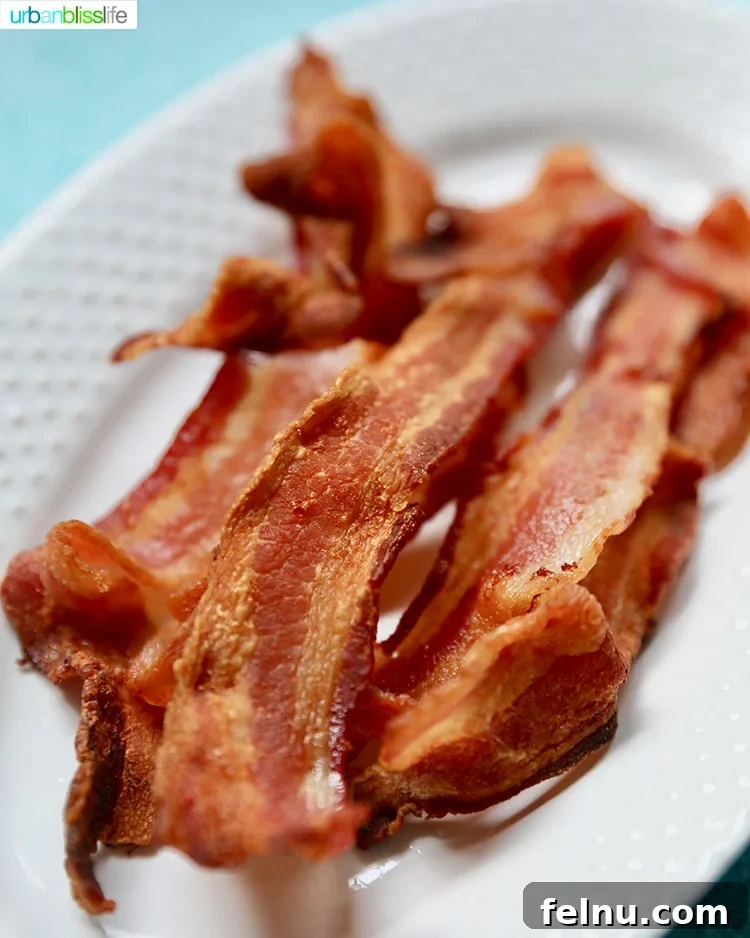Ultimate Air Fryer Bacon 3 Crispy Air Fryer Bacon on a plate, ready to be served