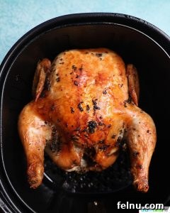 Just air fried Air Fryer Rotisserie Chicken inside the basket