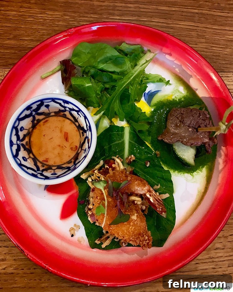 Portland's Farmhouse Table 8 A plate featuring two exquisite Thai appetizers: Neua Num Tok Rolls with beef and Mieng Kum Kung with prawns, from Farmhouse Kitchen Thai Cuisine Portland.