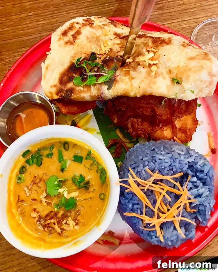 Portland's Farmhouse Table 9 The famous Hat Yai Fried Chicken from Farmhouse Kitchen Portland, featuring crispy chicken, turmeric, herbs, Roti bread, and blue rice.