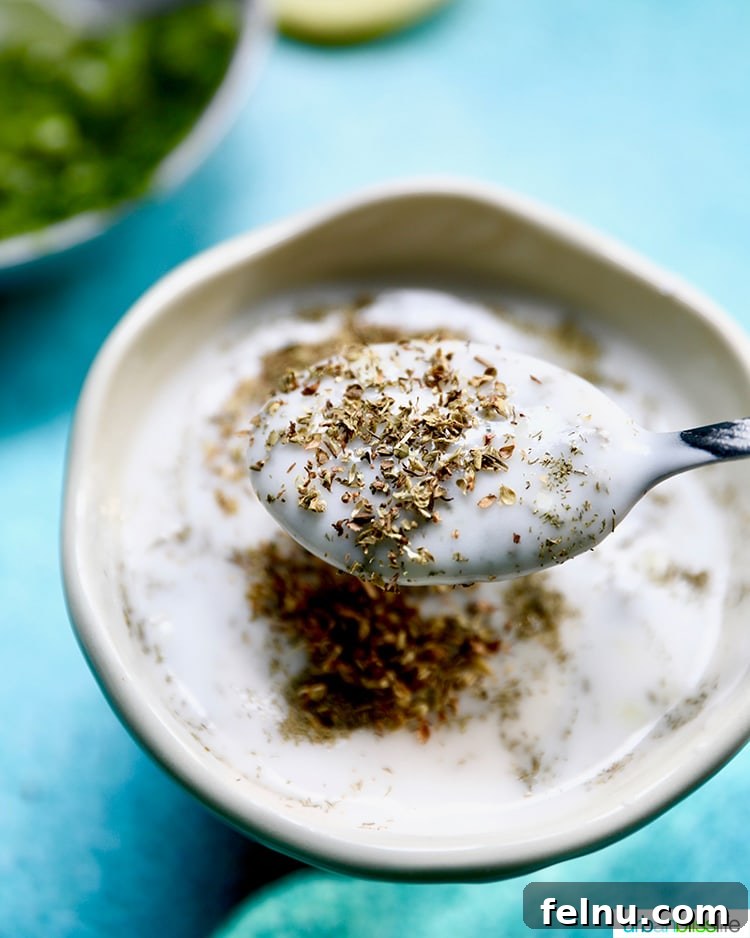 Zesty Vegan Tzatziki Dip 8 Greek herbs mixing into vegan tzatziki