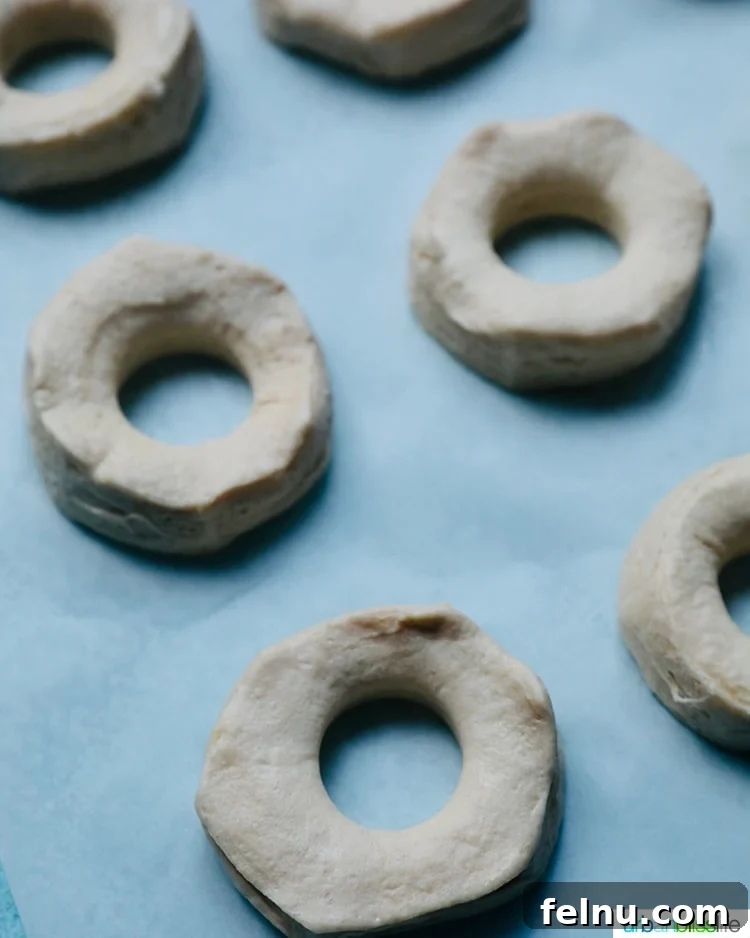 Effortless Air Fryer Doughnuts 7 biscuit dough cut out and ready to air fry
