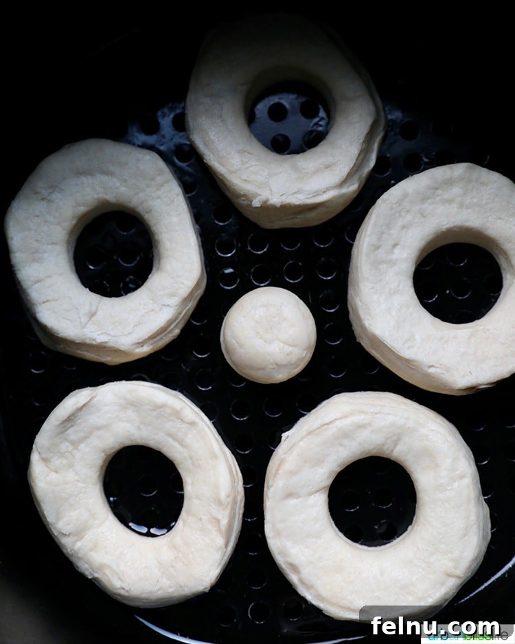 Effortless Air Fryer Doughnuts 8 donut shapes in air fryer basket