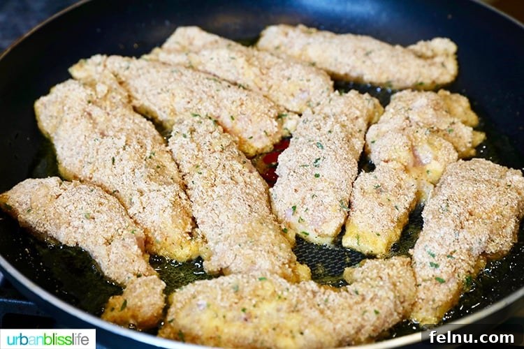 Frying chicken tenders in a pan