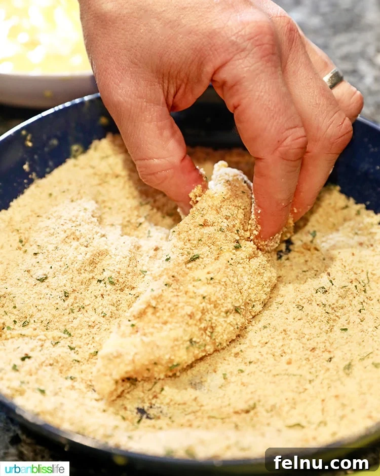 Coating chicken tenders in breadcrumbs