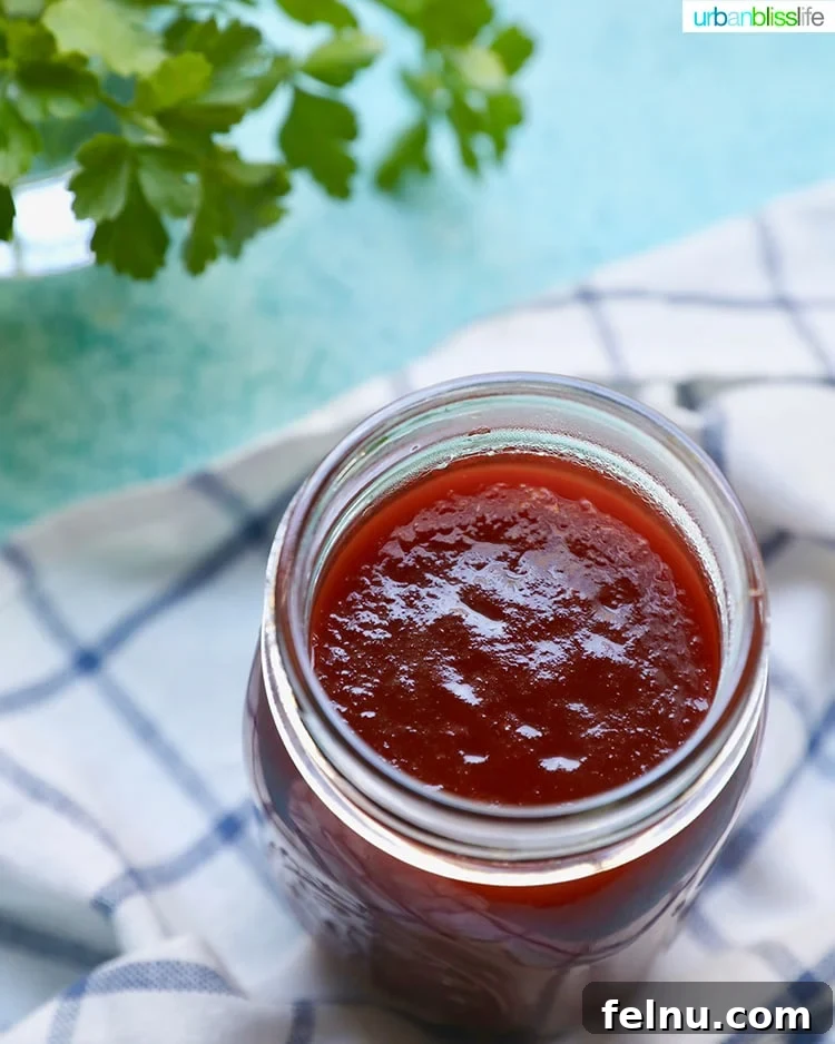 Sticky Sweet BBQ Perfection 3 An open mason jar of homemade sweet BBQ sauce, invitingly placed in a rustic setting.