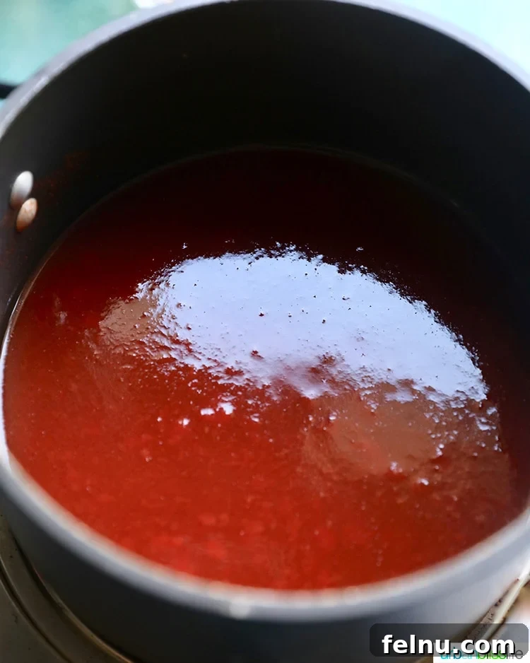 Sticky Sweet BBQ Perfection 6 Homemade sweet BBQ sauce simmering in a saucepan on the stove.