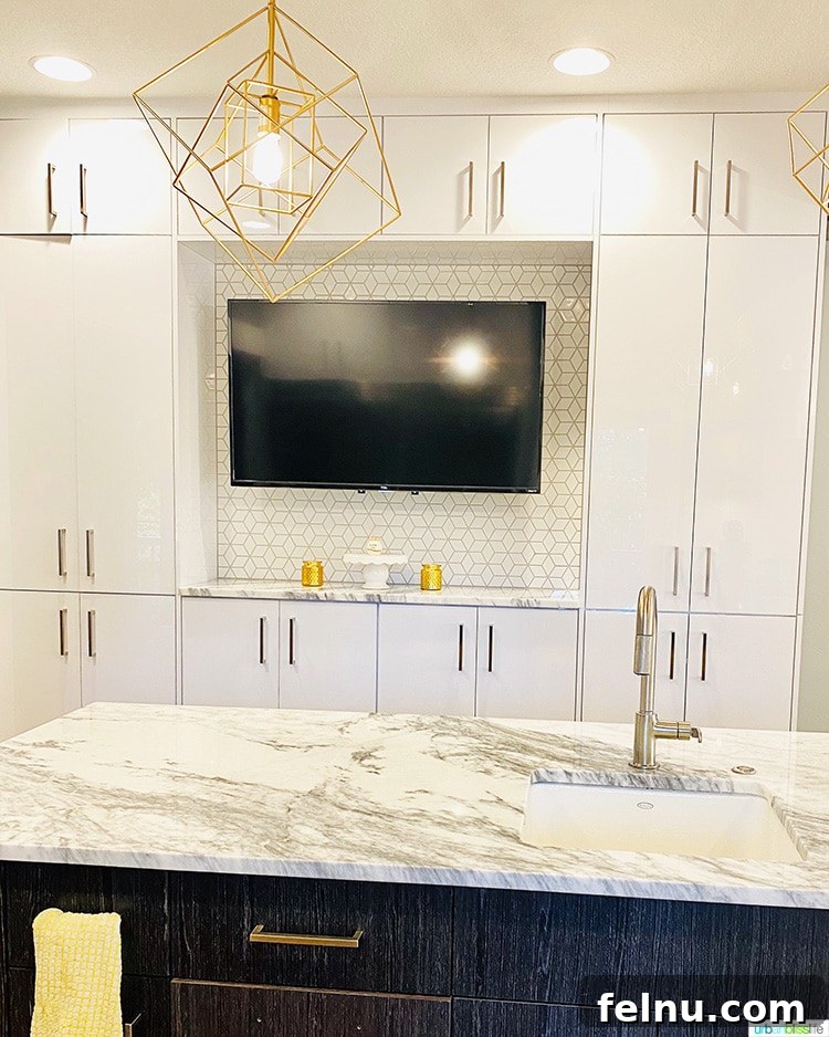 Kitchen TV and cabinets, kitchen island with sink and storage