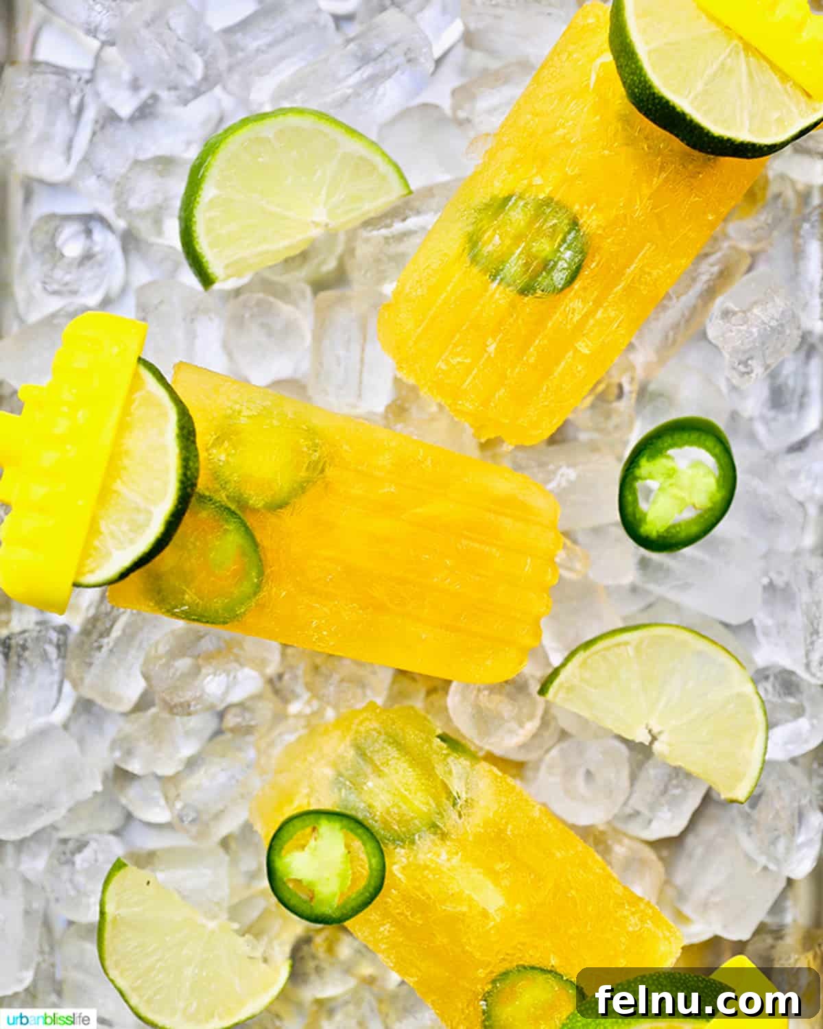 Island Oasis Margarita Pops 2 Three vibrant margarita popsicles, garnished with fresh lime and spicy jalapeno slices, nestled on a bed of ice.