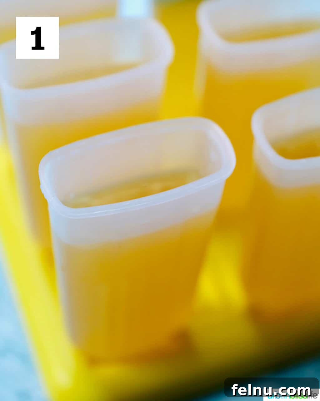 Island Oasis Margarita Pops 5 All ingredients for tropical margarita popsicles combined in a large glass jar, ready to be poured into molds.