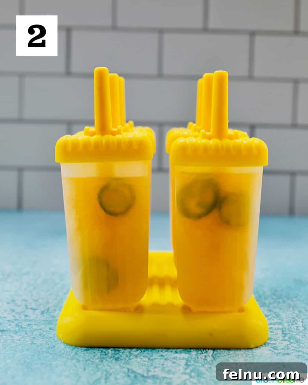 Island Oasis Margarita Pops 6 Tropical Margarita Popsicles mixture poured into individual popsicle molds, ready for freezing.