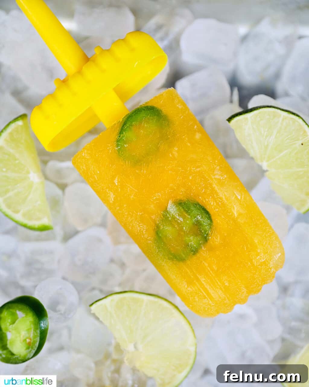 Island Oasis Margarita Pops 7 A vibrant yellow margarita popsicle with a stick partially removed, resting on a bed of ice.
