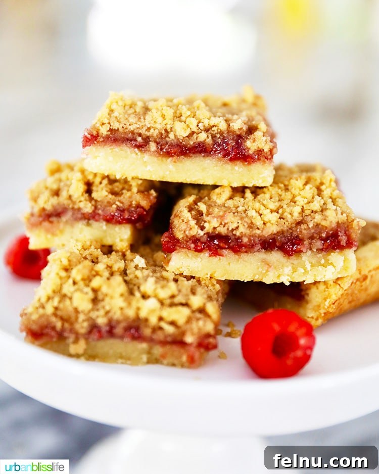 Raspberry Streusel Bars 9 Raspberry Crumble Bars stacked onto a pedestal