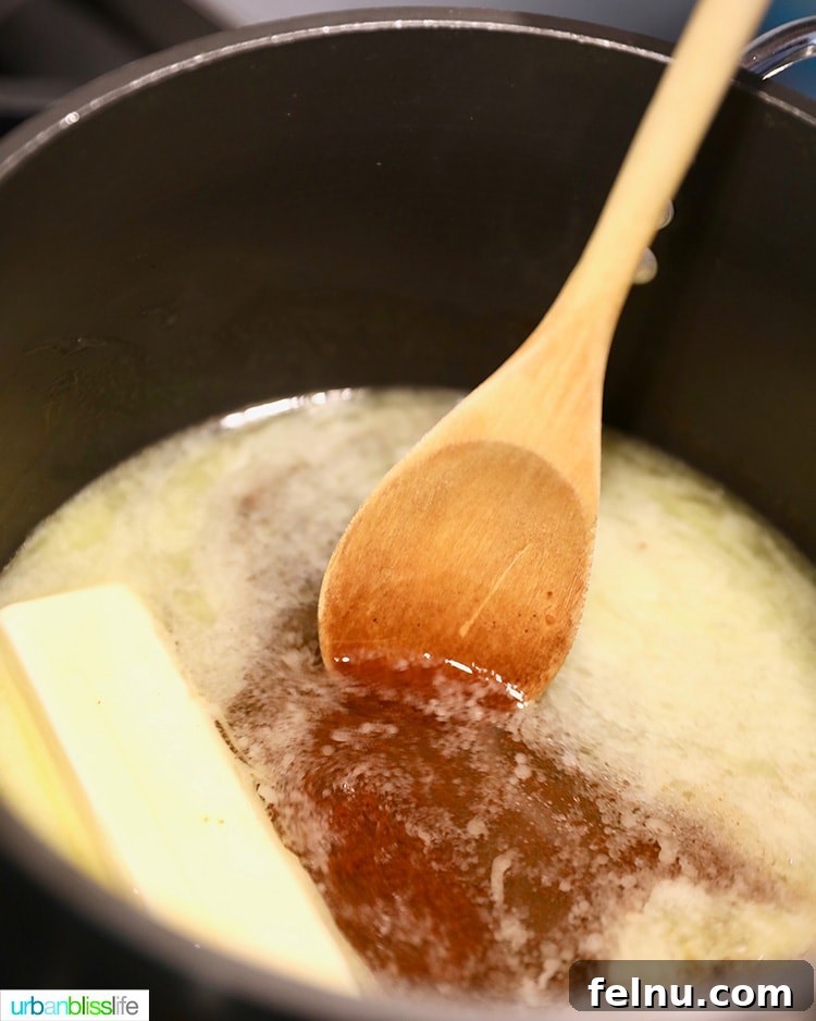 Melting butter in a saucepan for the churro dough.