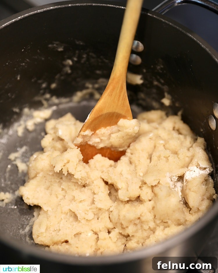 Stirring the ingredients to create a smooth churro dough.