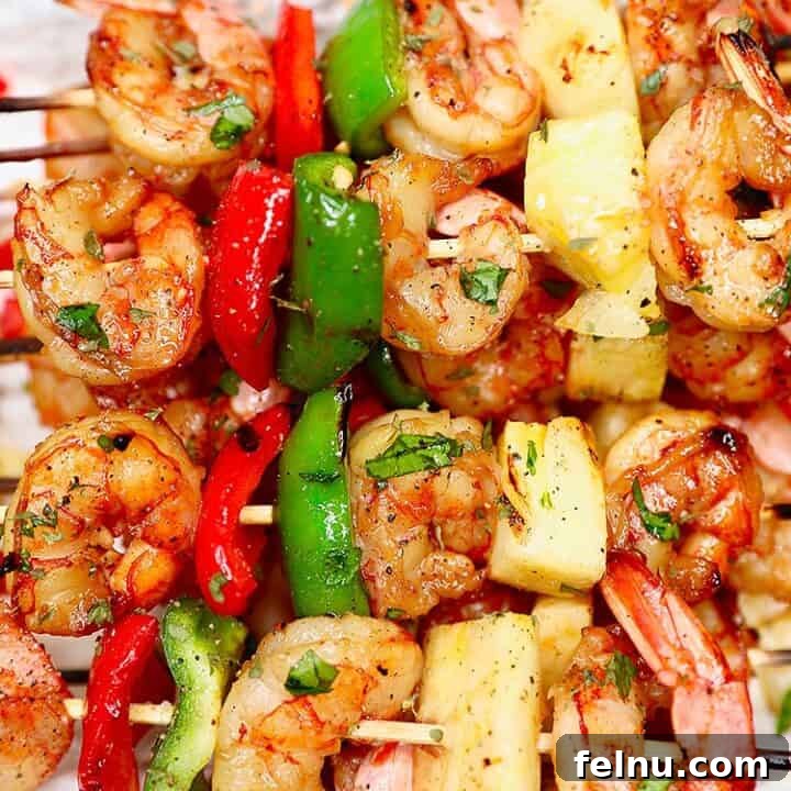 closeup of several grilled shrimp pineapple skewers served together