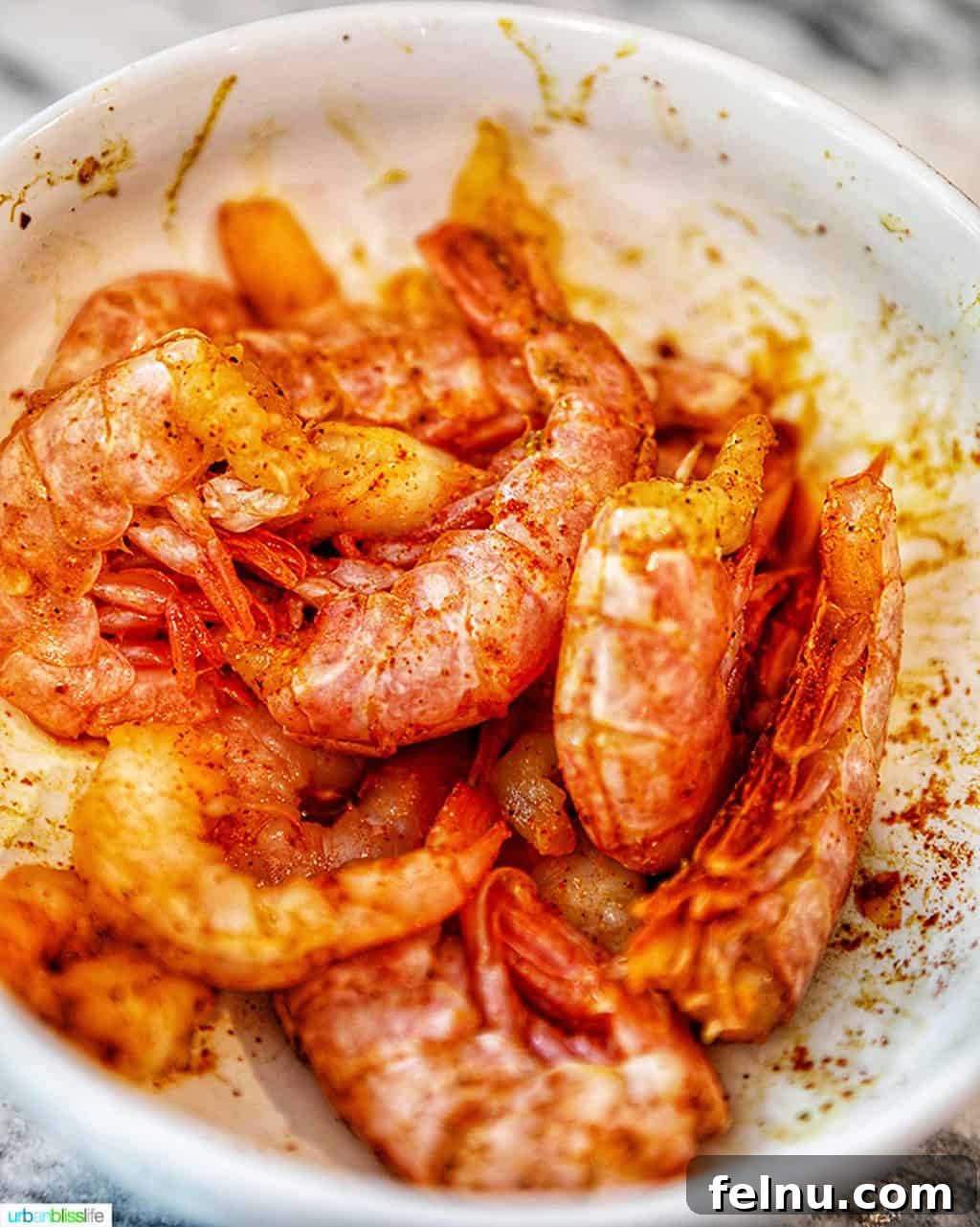 Creamy Coconut Curry Shrimp and Mushroom Medley 7 Plate of seasoned raw shrimp, ready for cooking