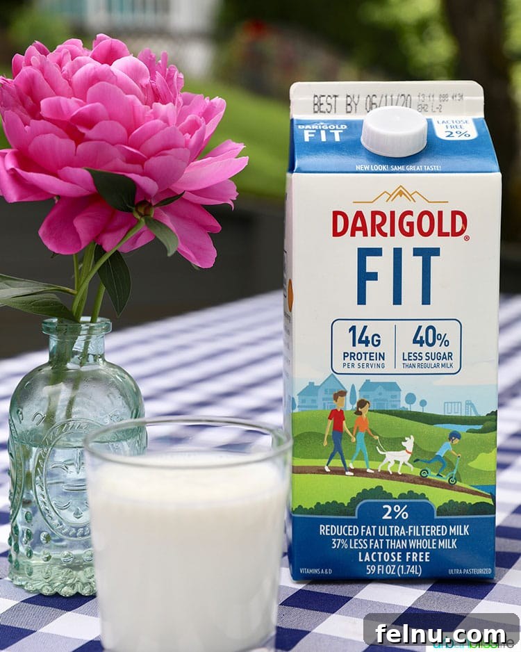 Elevate Your Everyday with Ultra-Filtered Milk 2 A refreshing glass of ultra-filtered milk next to its carton, highlighting its natural goodness.
