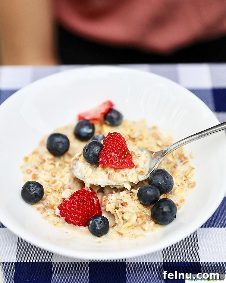 Elevate Your Everyday with Ultra-Filtered Milk 6 A bowl of creamy oatmeal adorned with a vibrant assortment of fresh berries, enhanced by ultra-filtered milk.