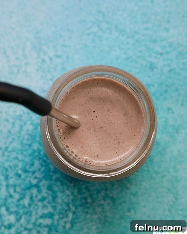 Elevate Your Everyday with Ultra-Filtered Milk 7 A dark, rich chocolate post-workout shake in a glass, ready for enjoyment.