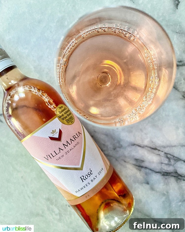 Toast to Summer: 12 Perfect Rosés for National Rosé Day 12 A bottle of Villa Maria 2019 Hawkes Bay Rosé alongside a glass of the wine, illustrating its inviting color and elegance.
