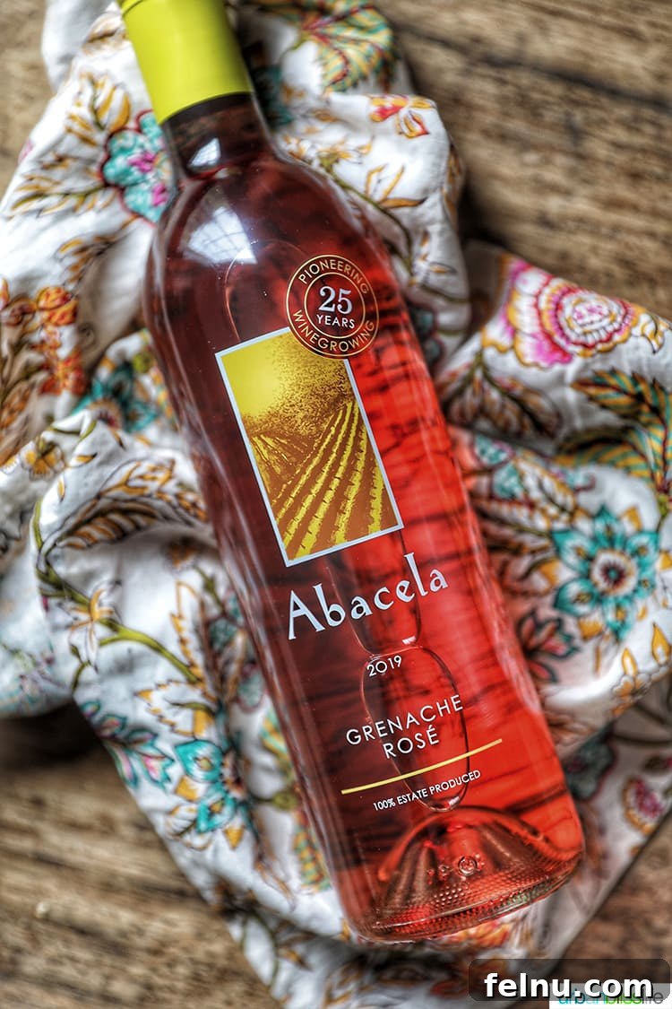 Toast to Summer: 12 Perfect Rosés for National Rosé Day 3 A bottle of Abacela 2019 Grenache Rosé, showcasing its elegant label and the wine's inviting pink hue.