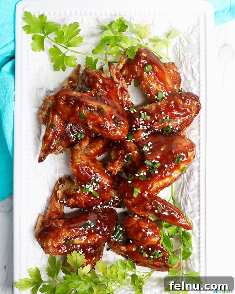 Sticky Teriyaki Air Fryer Wings 3 A white platter filled with air fryer teriyaki chicken wings, ready to serve.