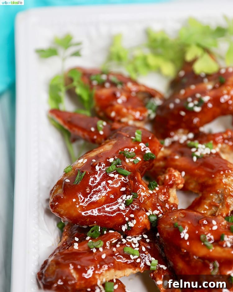 Sticky Teriyaki Air Fryer Wings 5 Close-up of air fryer teriyaki chicken wings, showing the sticky glaze and sesame seeds.