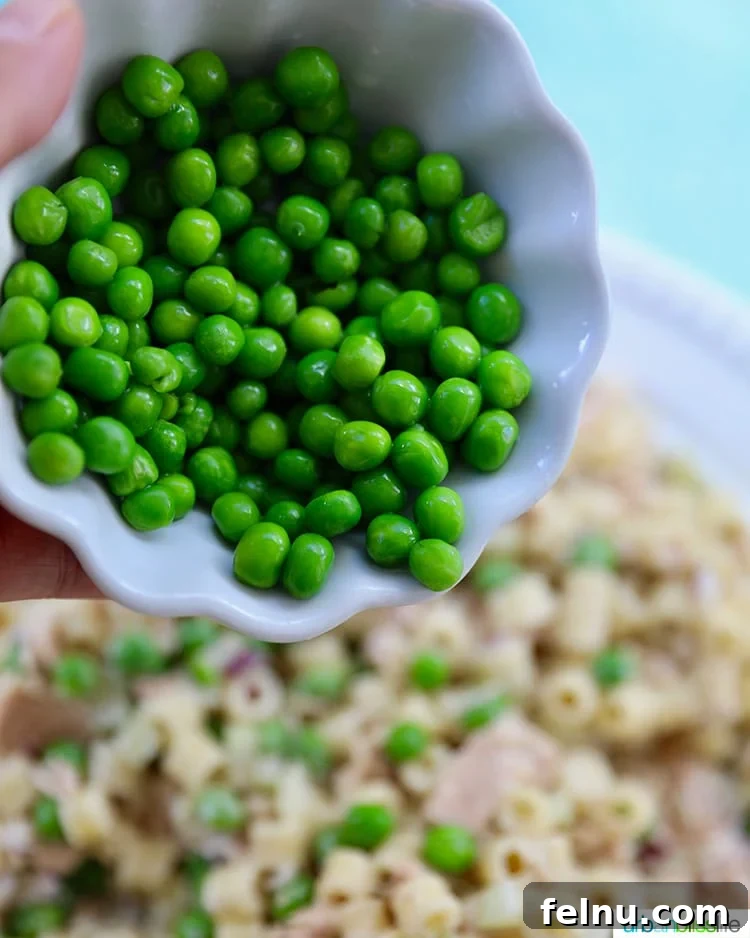 Creamy Tuna Pasta Salad 12 Adding peas to tuna pasta salad