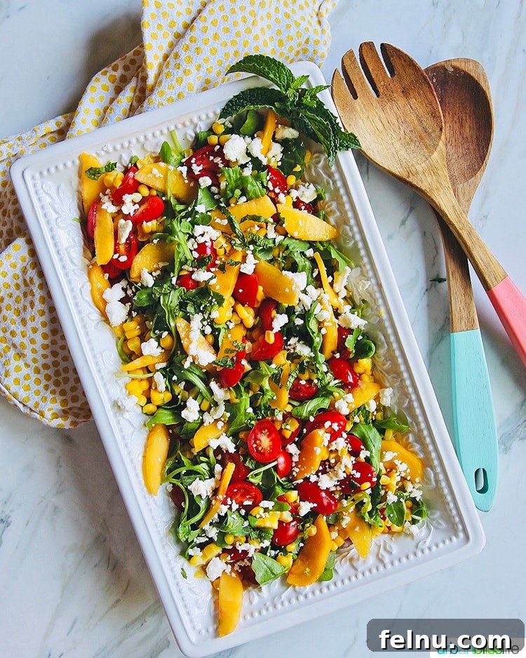Summer Peach and Tomato Salad 4 A large platter filled with vibrant Peach Tomato Salad, ready to be served.