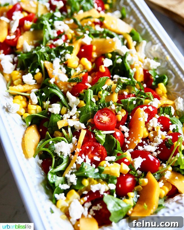 Summer Peach and Tomato Salad 5 Peach Tomato Salad with feta and arugula presented beautifully on a white platter.